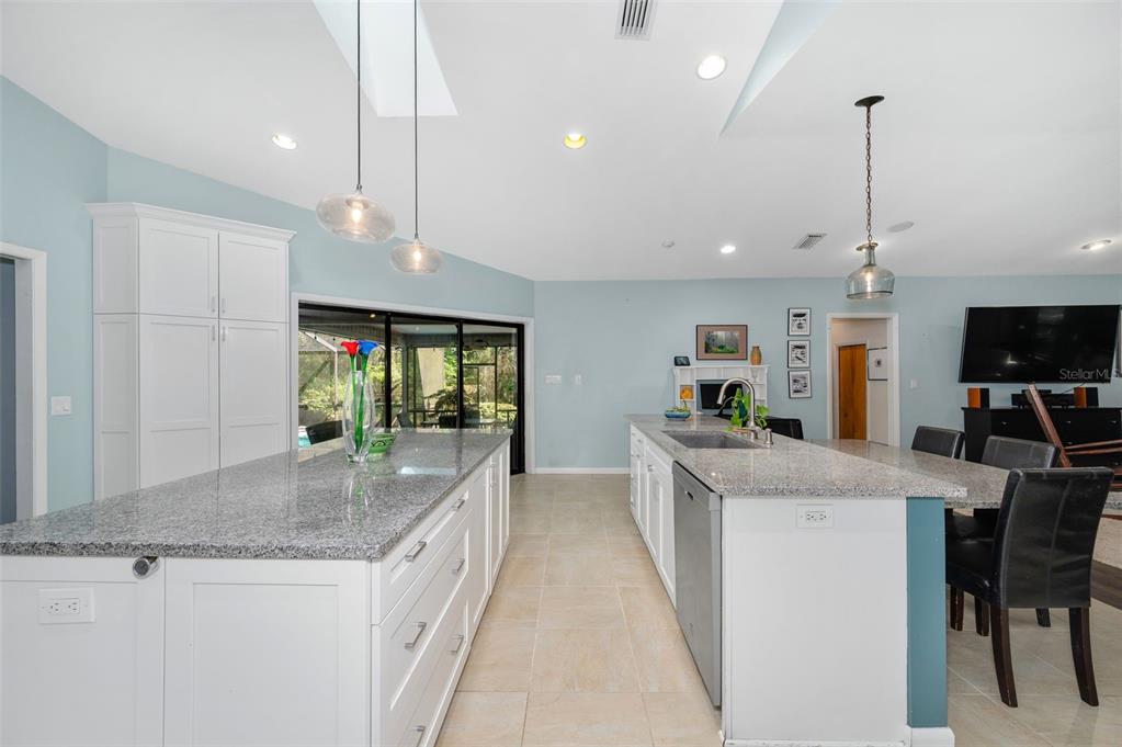 9923 Southwest 2nd Place Gainesville, FL 32607 - Photo 12 of 73 a kitchen with kitchen island granite countertop a stove and a sink with granite countertops