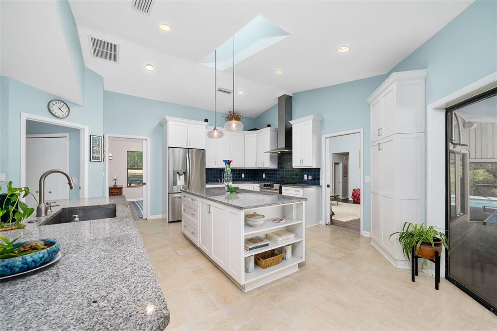 9923 Southwest 2nd Place Gainesville, FL 32607 - Photo 18 of 73 a kitchen with stainless steel appliances kitchen island a refrigerator and a stove