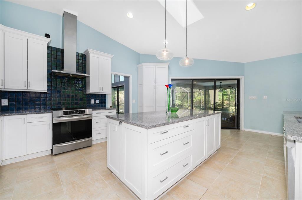 9923 Southwest 2nd Place Gainesville, FL 32607 - Photo 20 of 73 a kitchen with granite countertop white cabinets and white appliances