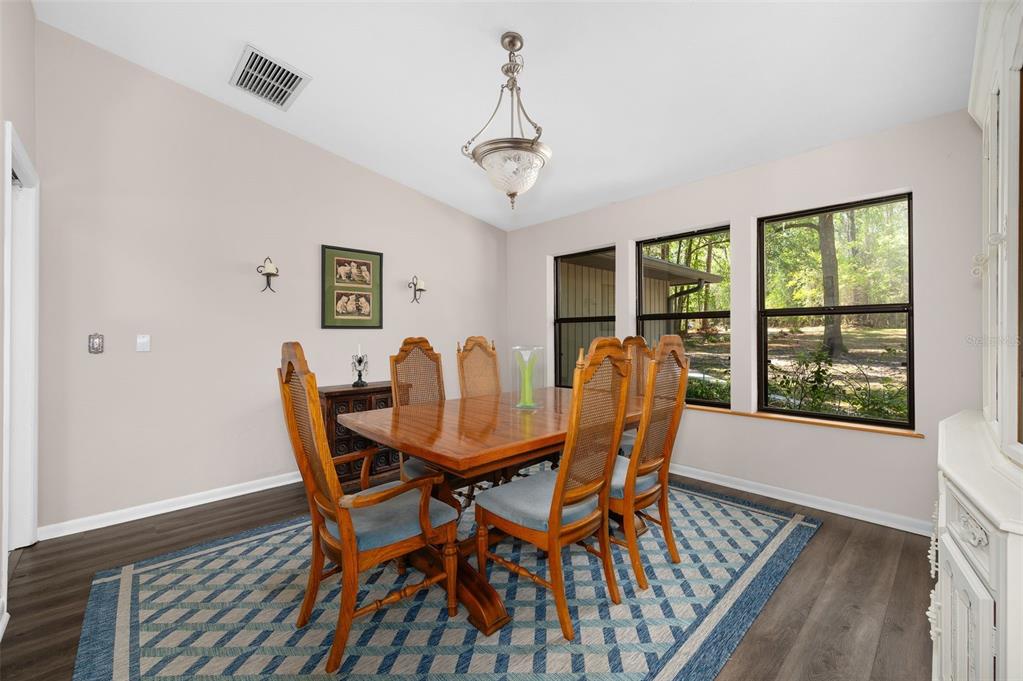 9923 Southwest 2nd Place Gainesville, FL 32607 - Photo 22 of 73 a view of a dining room with furniture window and wooden floor