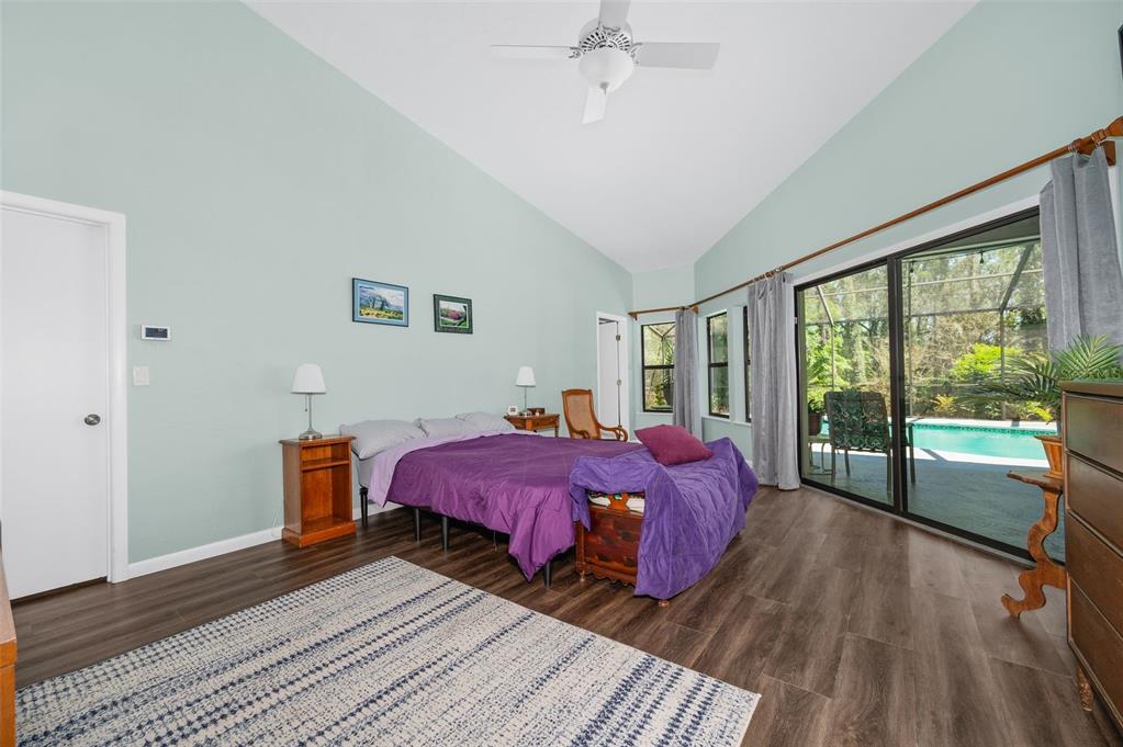 9923 Southwest 2nd Place Gainesville, FL 32607 - Photo 25 of 73 a spacious bedroom with a bed and wooden floor