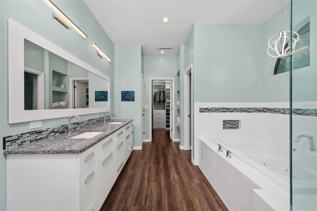 9923 Southwest 2nd Place Gainesville, FL 32607 - Photo 27 of 73 a bathroom with a granite countertop sink a bathtub and shower