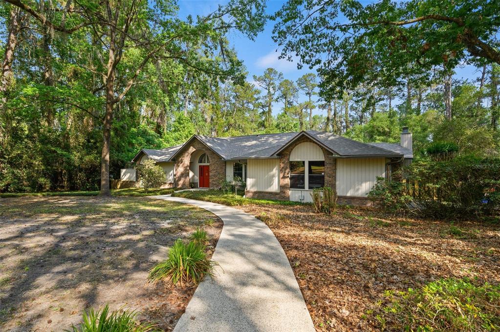 9923 Southwest 2nd Place Gainesville, FL 32607 - Photo 3 of 73 a view of a house with a yard
