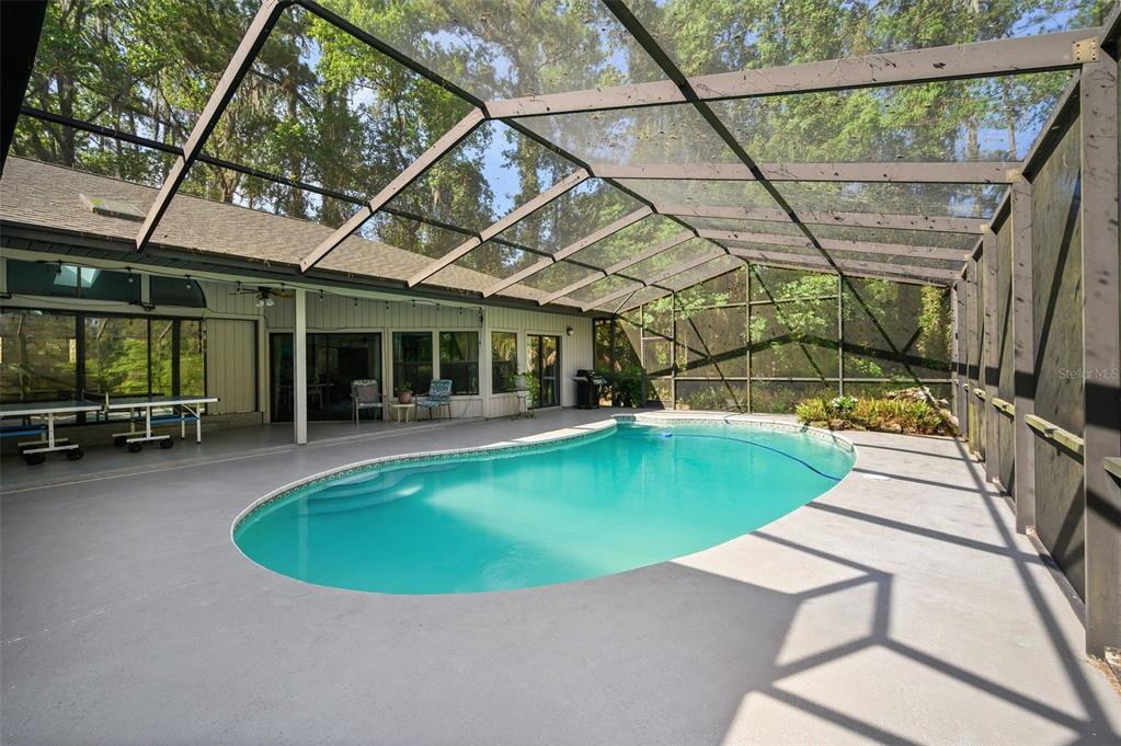 9923 Southwest 2nd Place Gainesville, FL 32607 - Photo 52 of 73 a view of a swimming pool with a patio and a yard