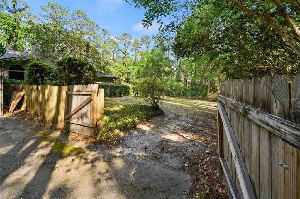 9923 Southwest 2nd Place Gainesville, FL 32607 - Photo 68 of 73 a view of a pathway of a yard