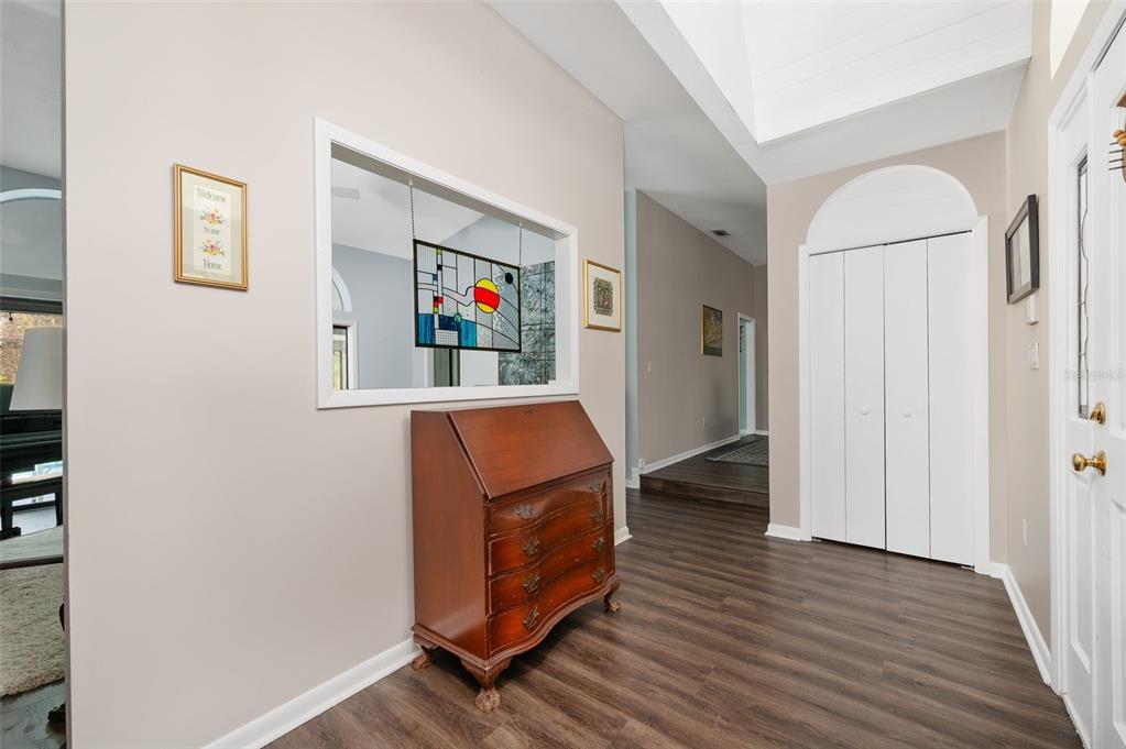 9923 Southwest 2nd Place Gainesville, FL 32607 - Photo 7 of 73 a view of a hallway with wooden floor and furniture