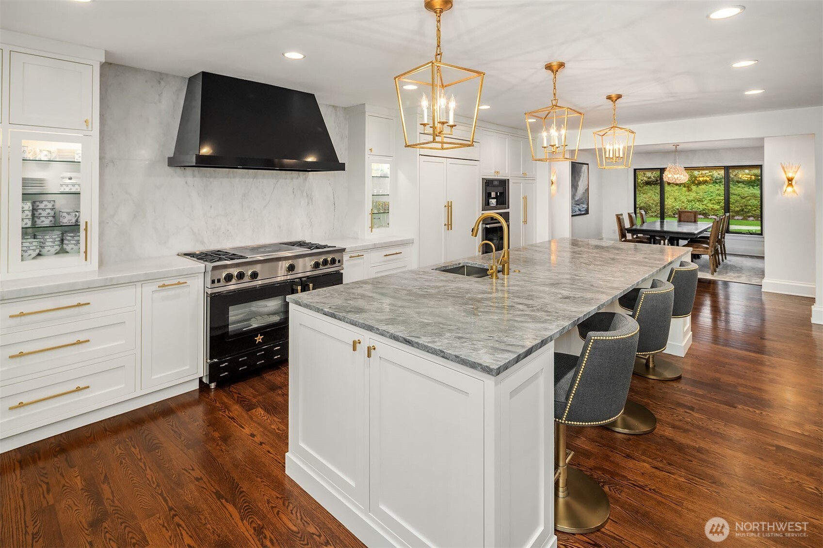 1601 Evergreen Point Road Medina, WA 98039 - Photo 11 of 40 a kitchen with granite countertop a stove a sink a microwave and living room view