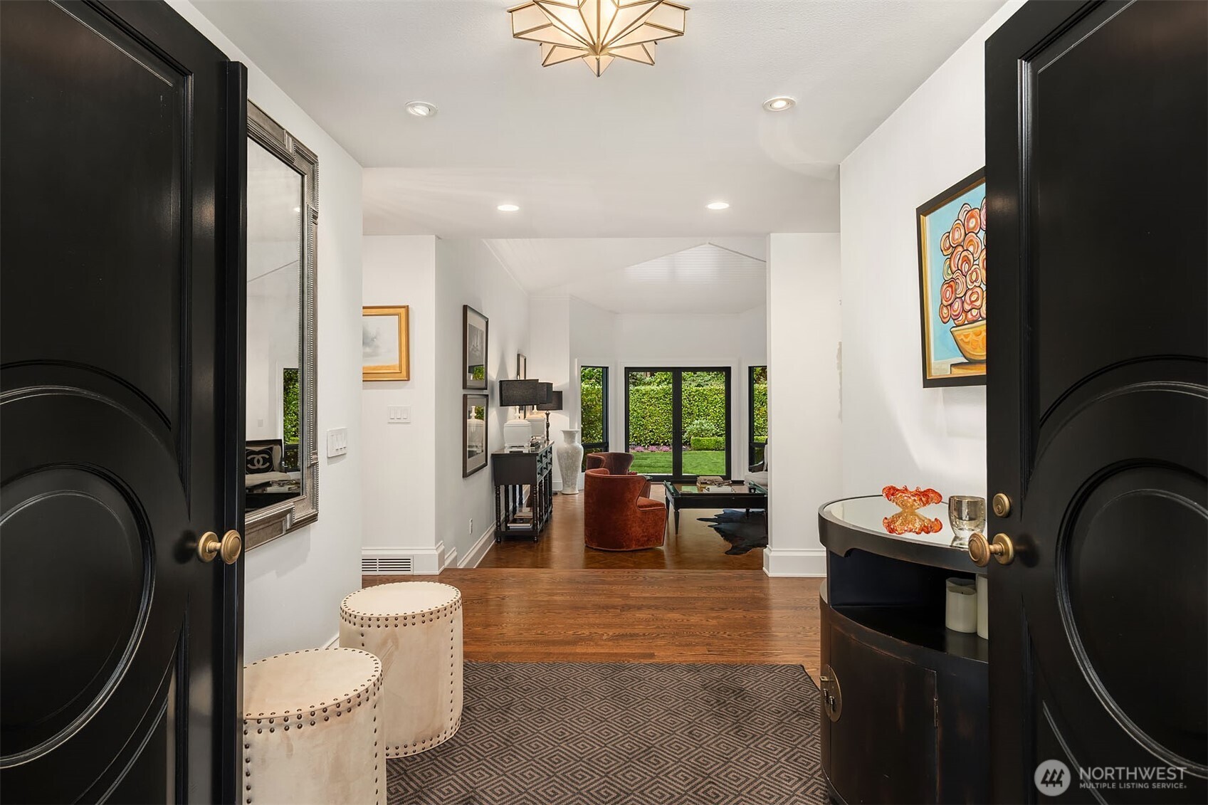 1601 Evergreen Point Road Medina, WA 98039 - Photo 5 of 40 a living room with furniture a rug a fireplace and a large window