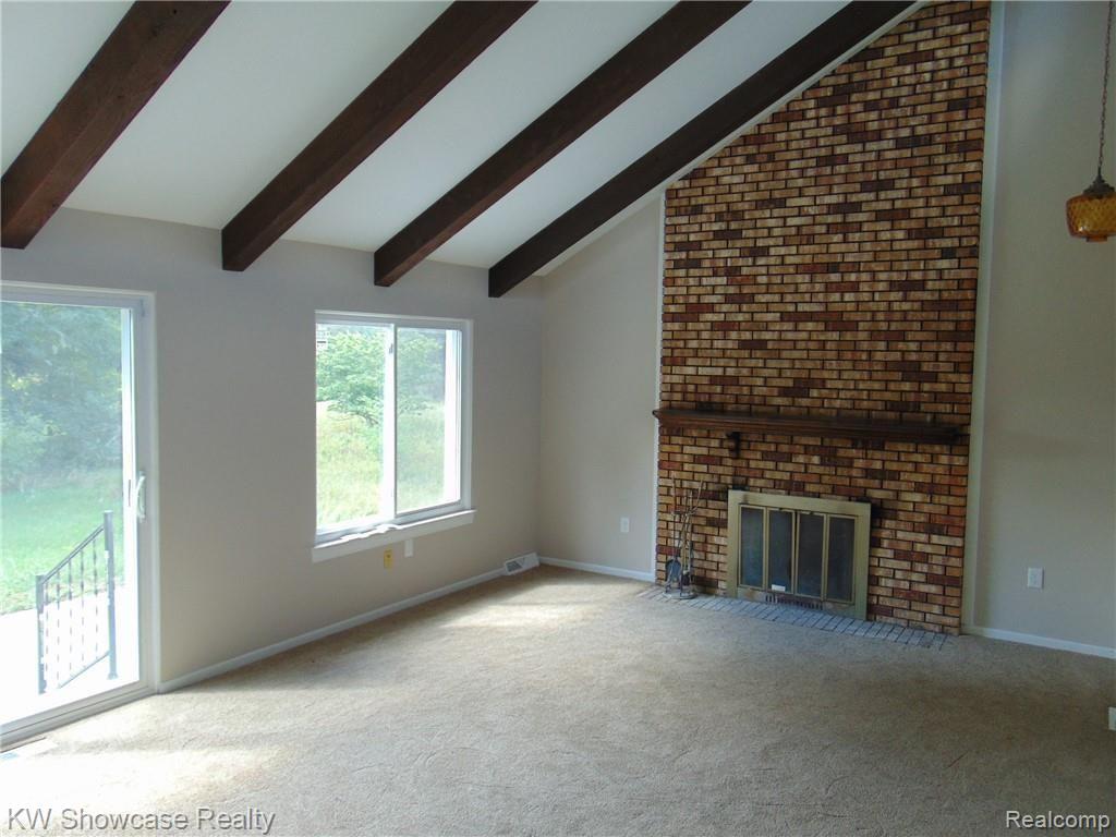 GREAT ROOM WITH BRICK FIREPLACE AND VAULTED CEILINGS