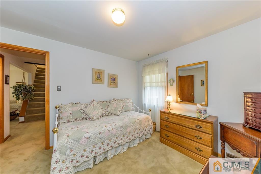26 Middlesex Road Matawan, NJ 07747 - Photo 14 of 23 a bedroom with a bed and a dresser