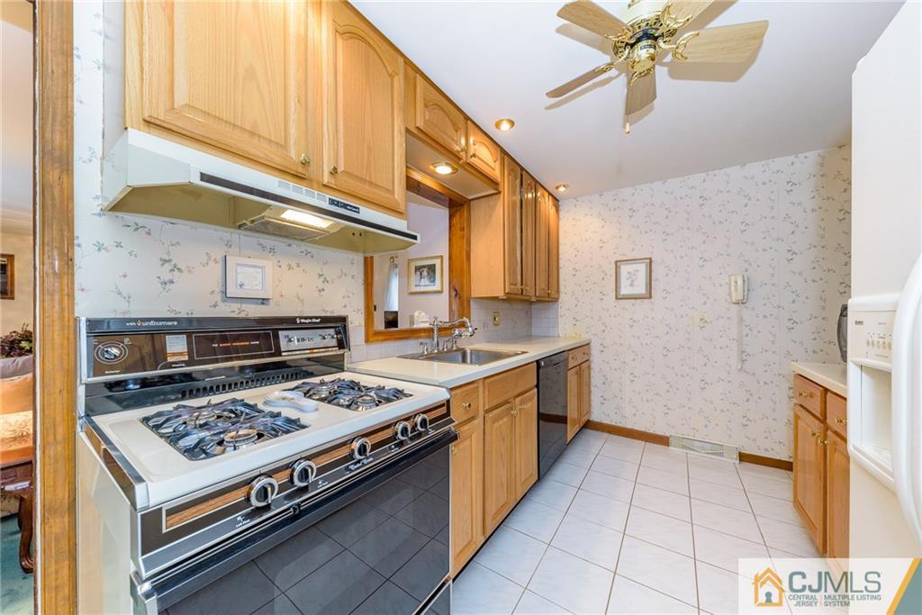 26 Middlesex Road Matawan, NJ 07747 - Photo 7 of 23 a kitchen with a stove a sink and a refrigerator