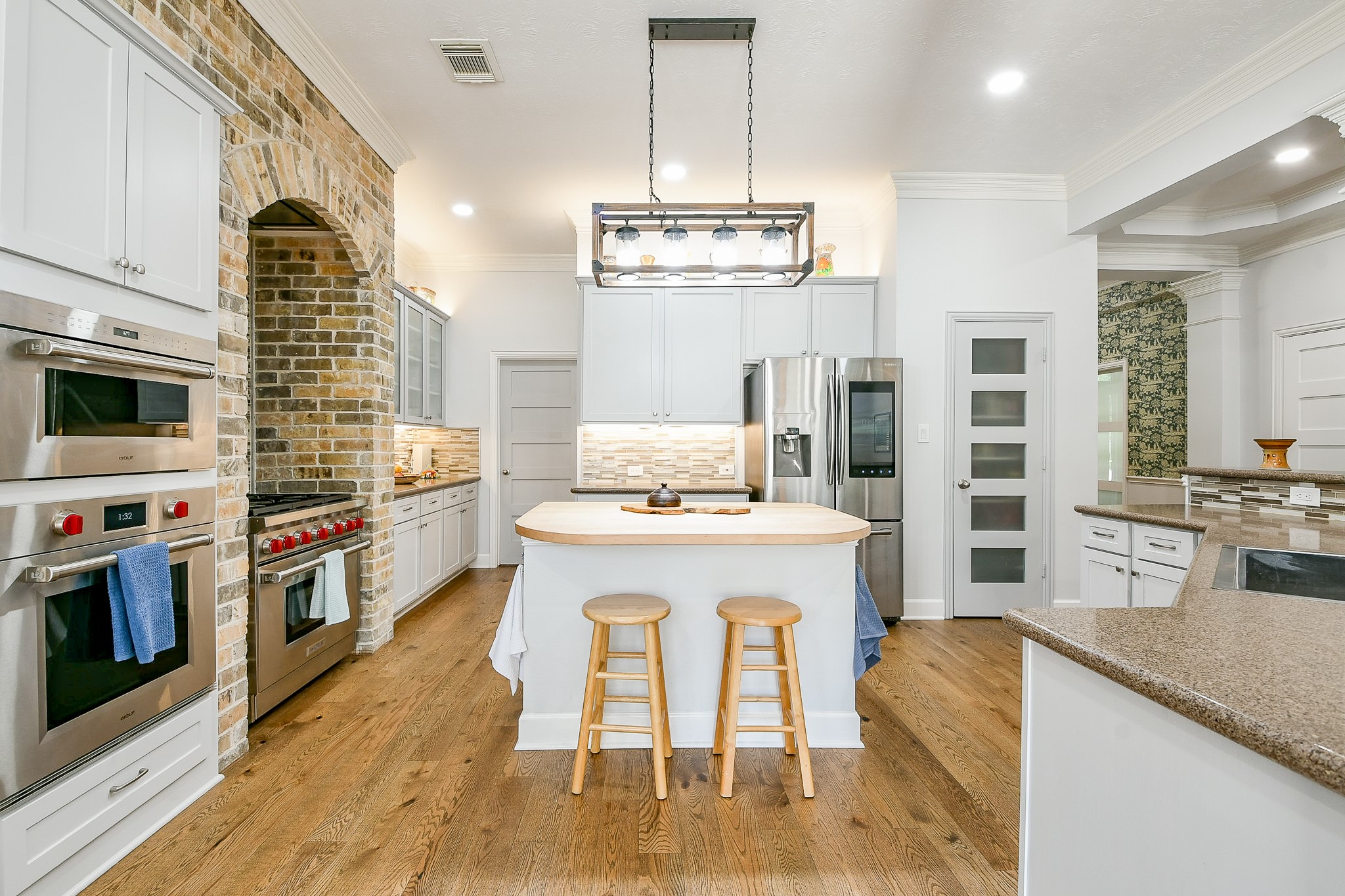 2442 Chimney Rock Road Houston, TX 77057 - Photo 15 of 50 a kitchen with stainless steel appliances granite countertop a stove and a white cabinets