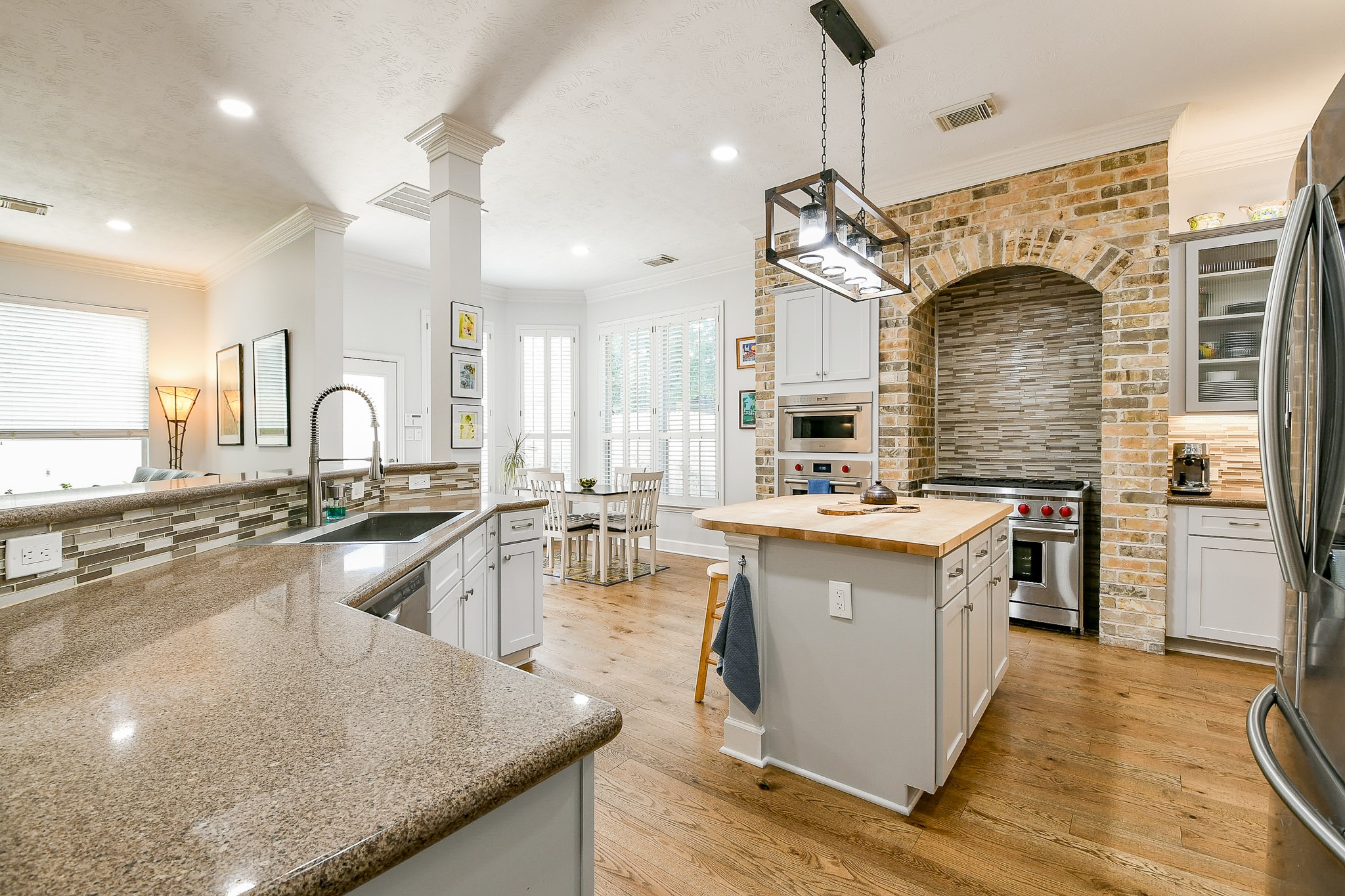 2442 Chimney Rock Road Houston, TX 77057 - Photo 16 of 50 a large kitchen with granite countertop a sink counter top space a stove and cabinets