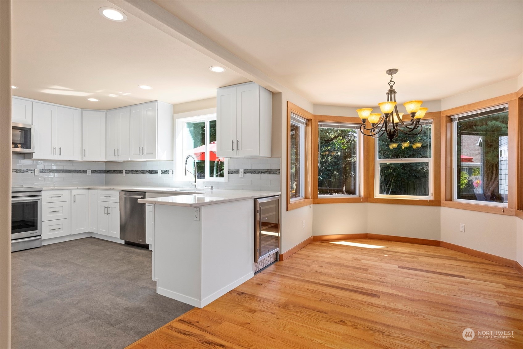 1311 Roma Road Bellingham, WA 98226 - Photo 8 of 38 a kitchen that has a lot of white cabinets and a wooden floor
