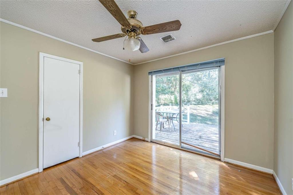 135 Benton Drive Northwest Rome, GA 30165 - Photo 13 of 16 a view of an empty room with wooden floor and a window