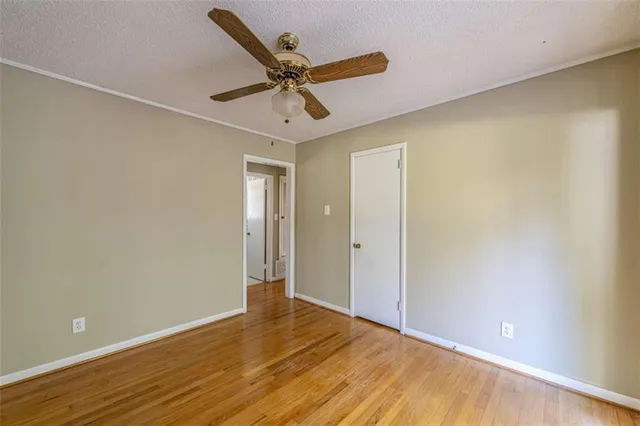 a view of a livingroom with a ceiling fan and wooden floor