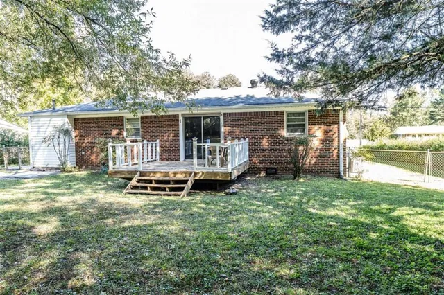 a backyard of a house with yard table and chairs