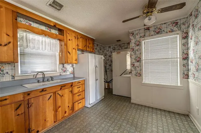 a bathroom with a granite countertop sink a mirror and a shower