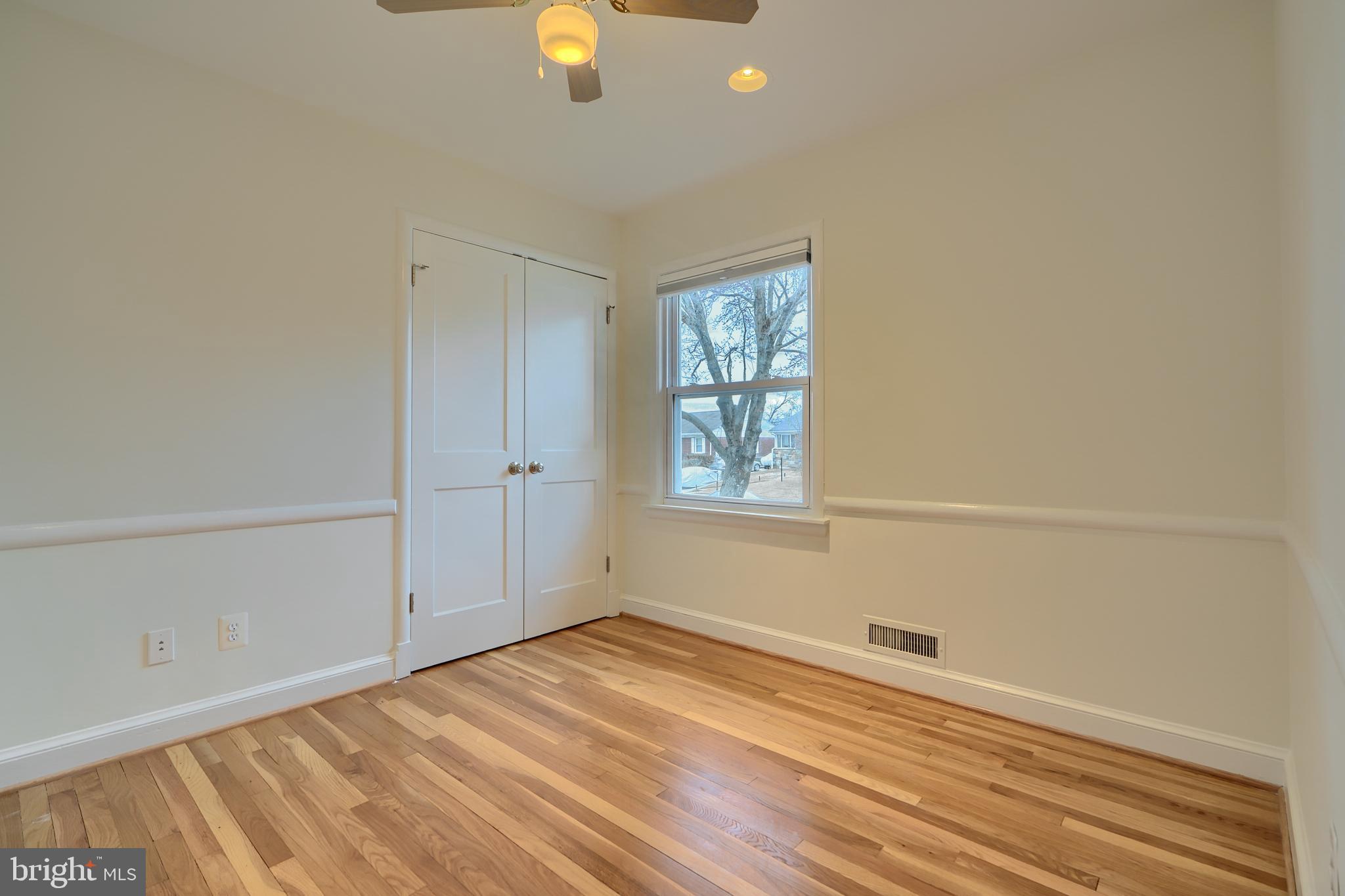 9715 Saxony Road Silver Spring, MD 20910 - Photo 13 of 31 wooden floor in an empty room with a window