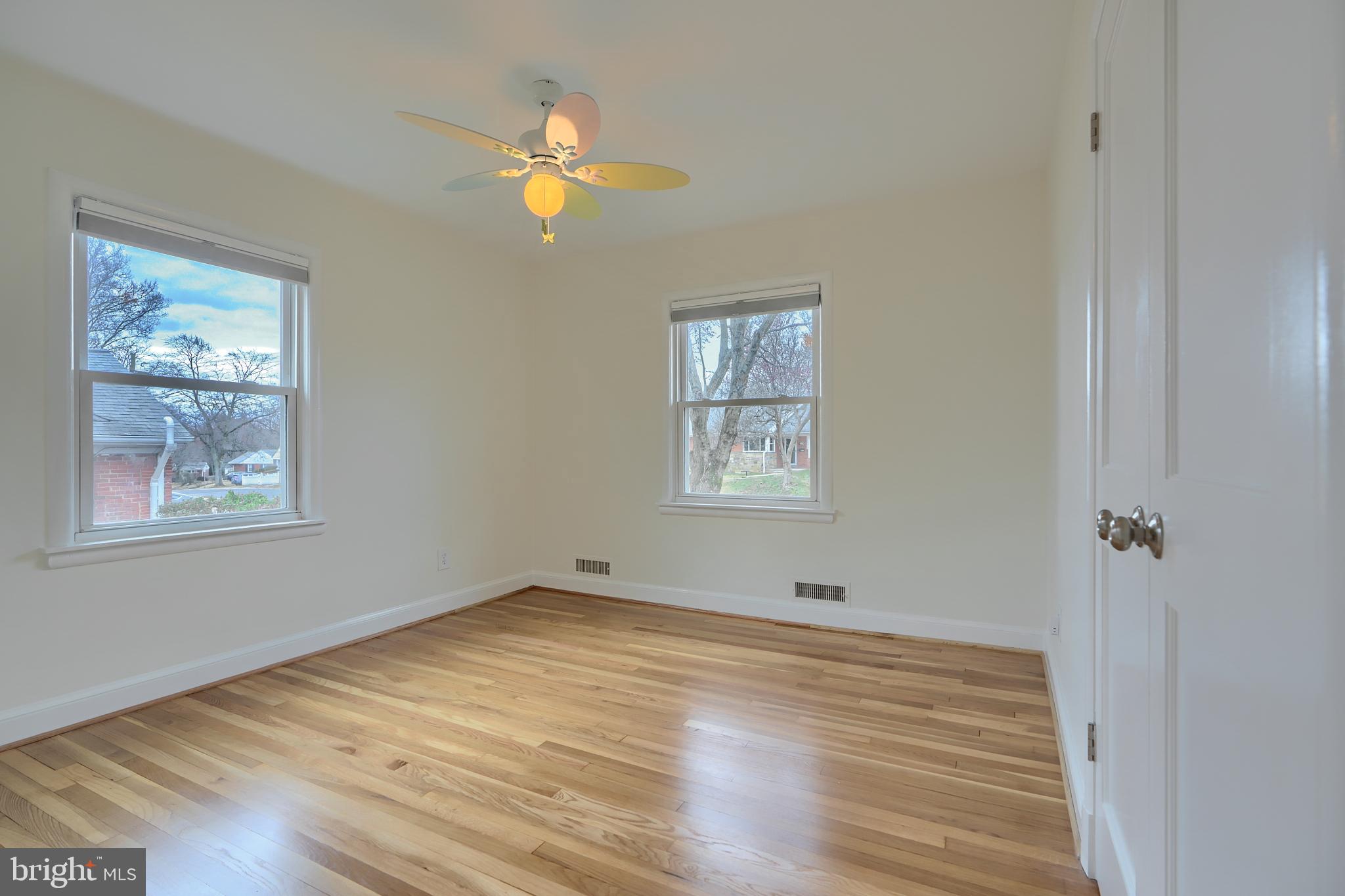 9715 Saxony Road Silver Spring, MD 20910 - Photo 14 of 31 a view of an empty room with wooden floor and a window