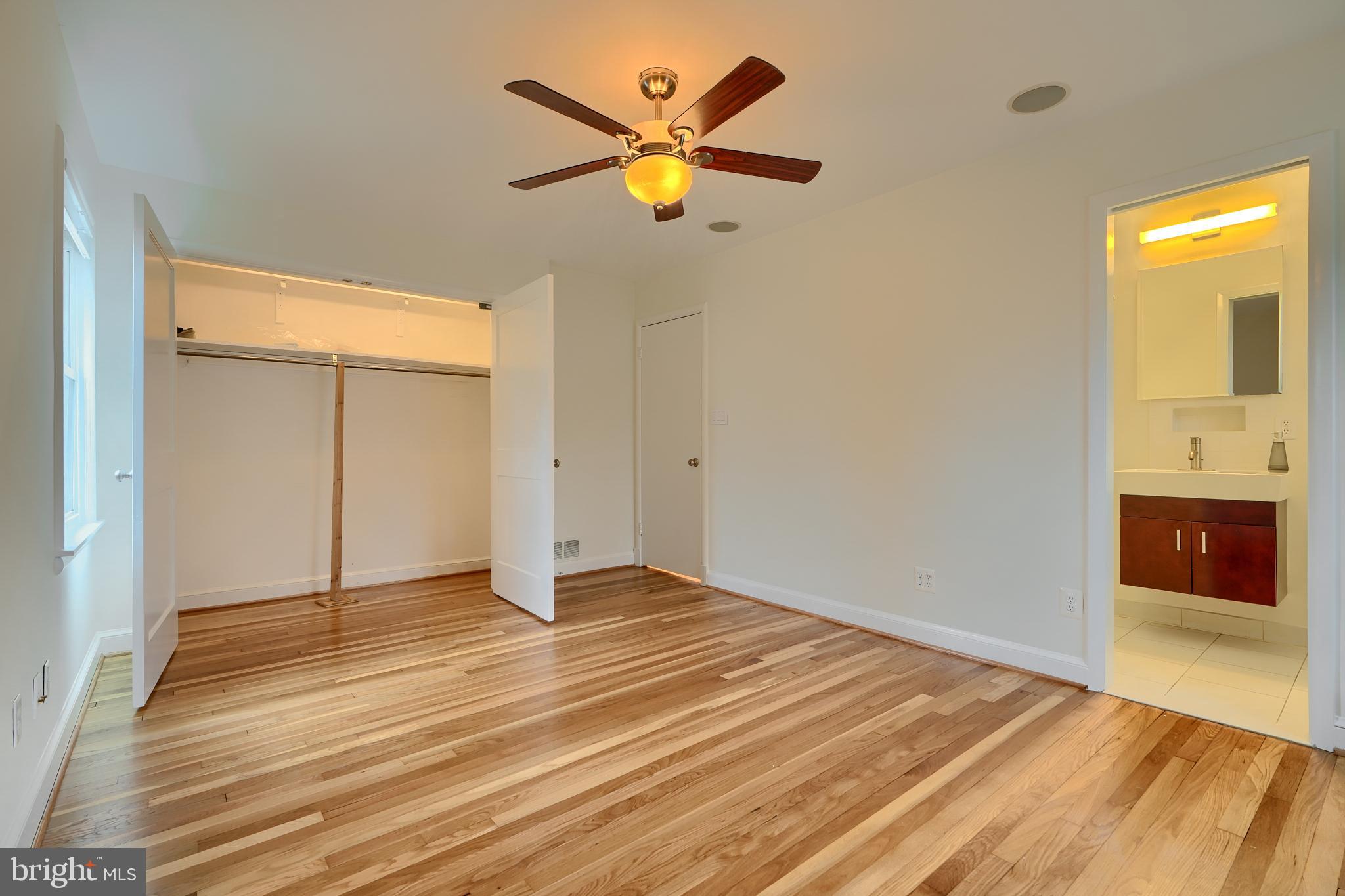 9715 Saxony Road Silver Spring, MD 20910 - Photo 18 of 31 wooden floor in an empty room with a window