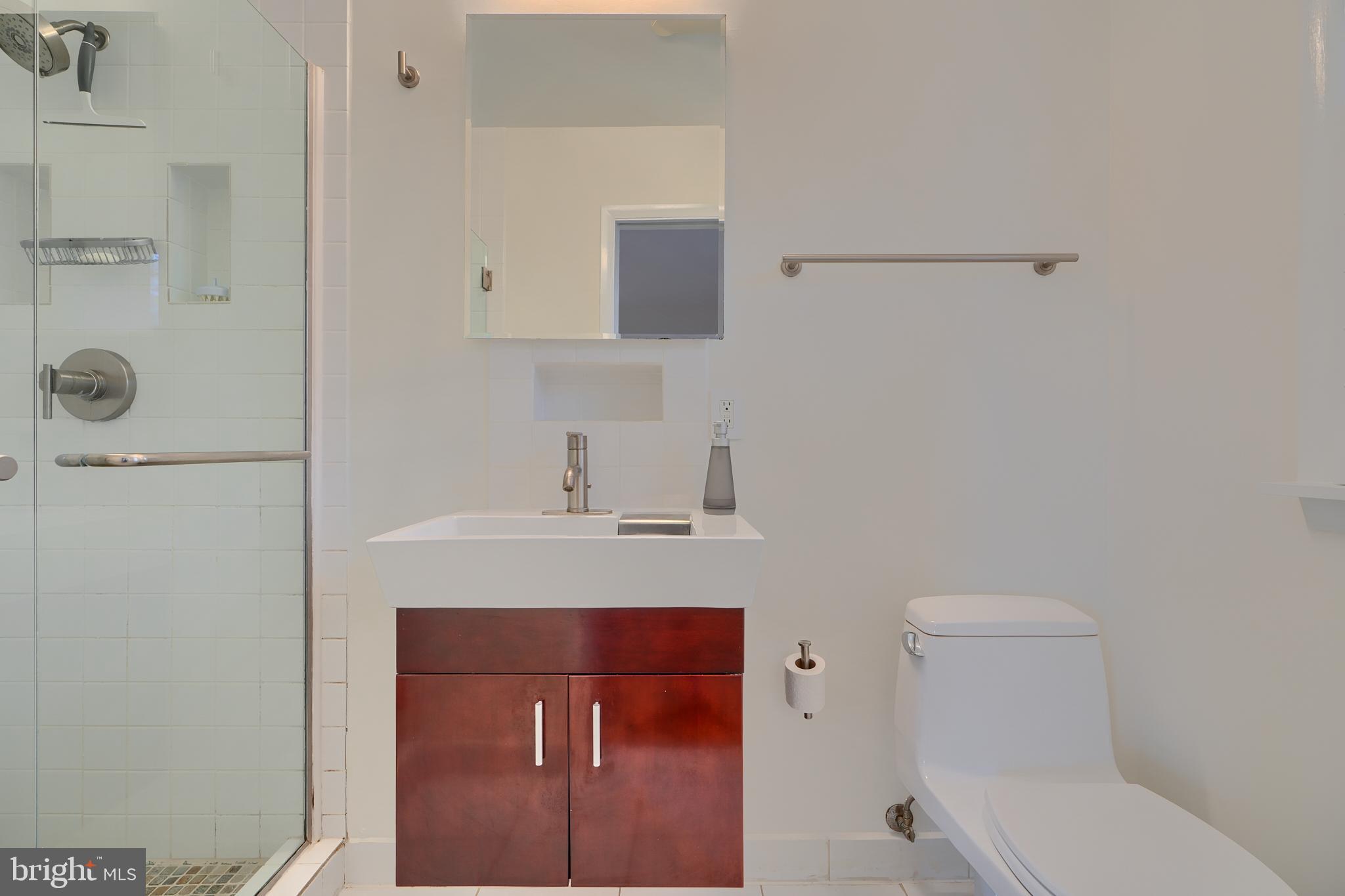 9715 Saxony Road Silver Spring, MD 20910 - Photo 19 of 31 a bathroom with a toilet a sink and mirror