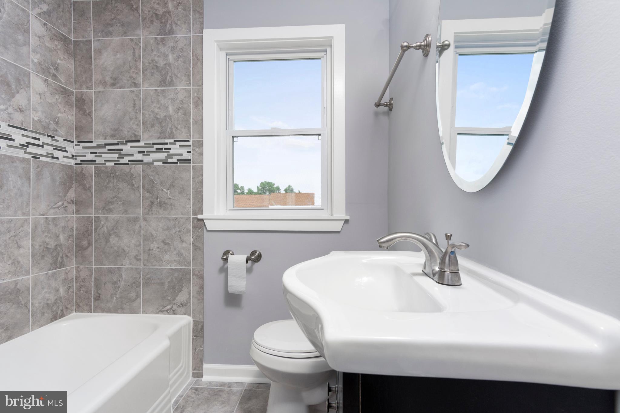 209 West Meadow Road Baltimore, MD 21225 - Photo 13 of 29 a bathroom with a sink toilet and shower