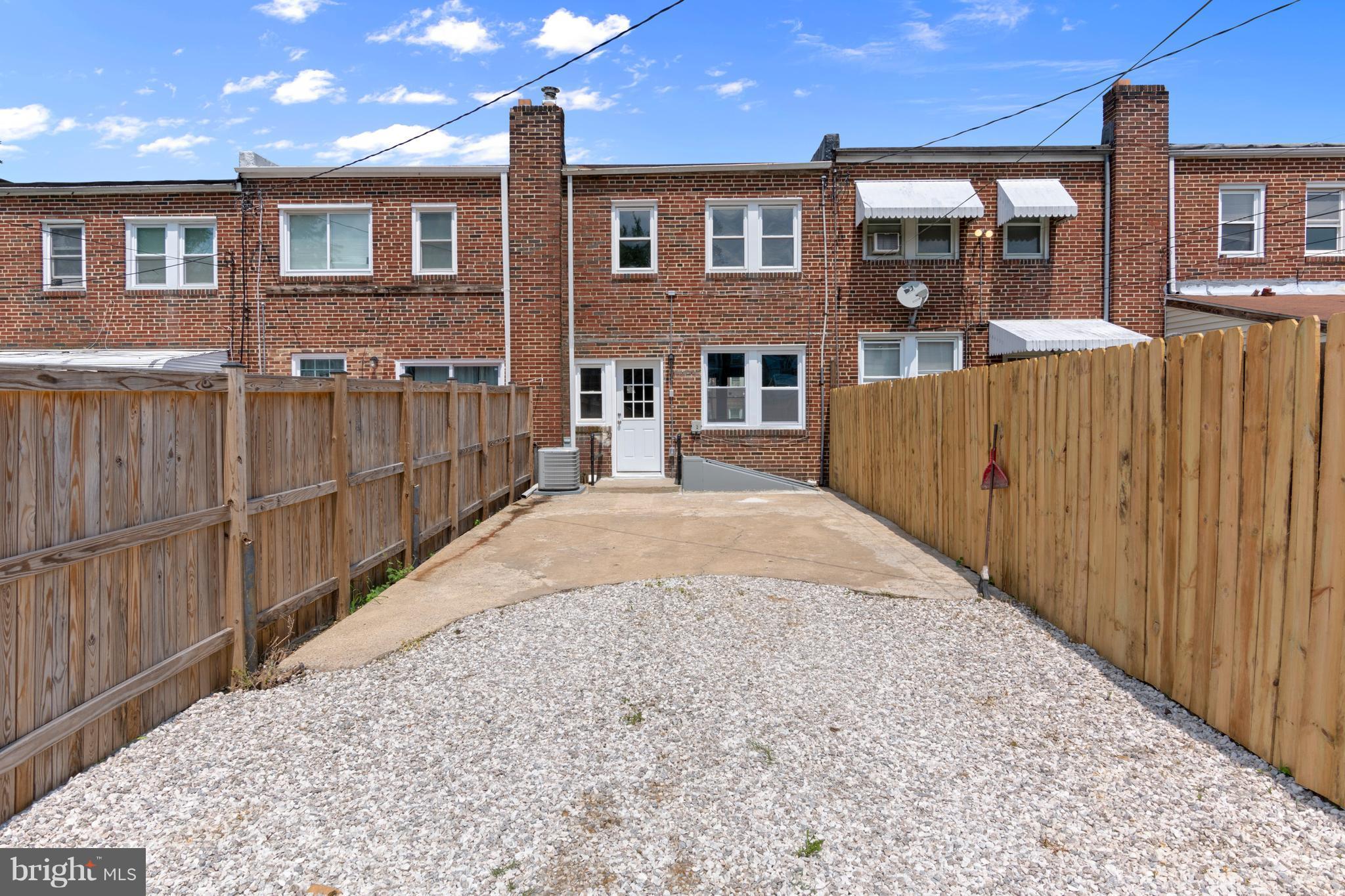209 West Meadow Road Baltimore, MD 21225 - Photo 25 of 29 a view of a brick house with wooden fence