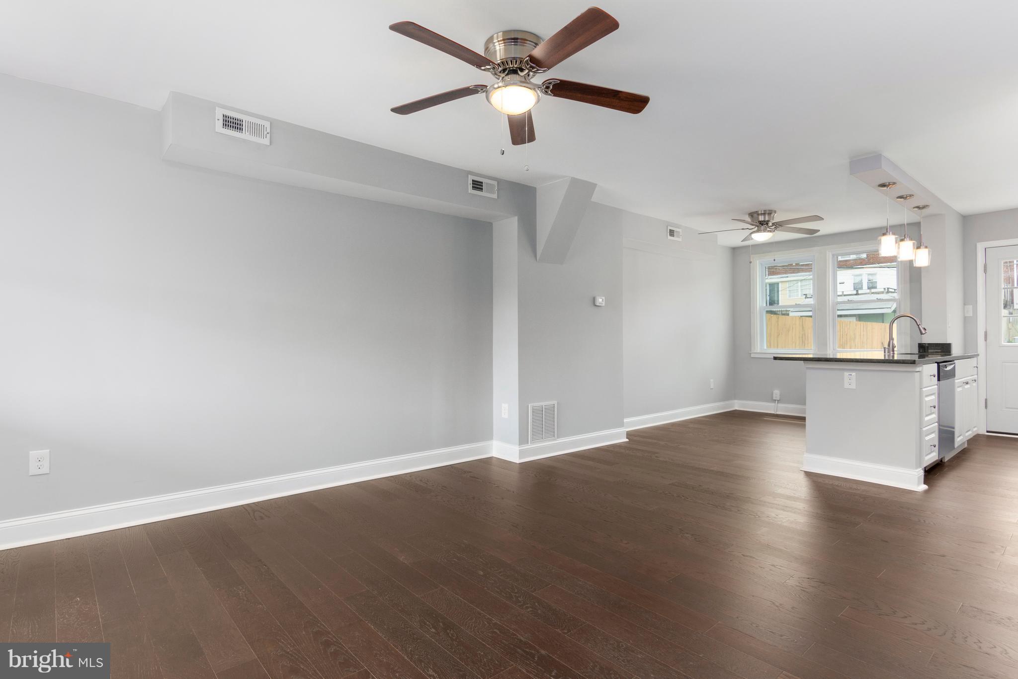 209 West Meadow Road Baltimore, MD 21225 - Photo 4 of 29 wooden floor in an empty room and a window