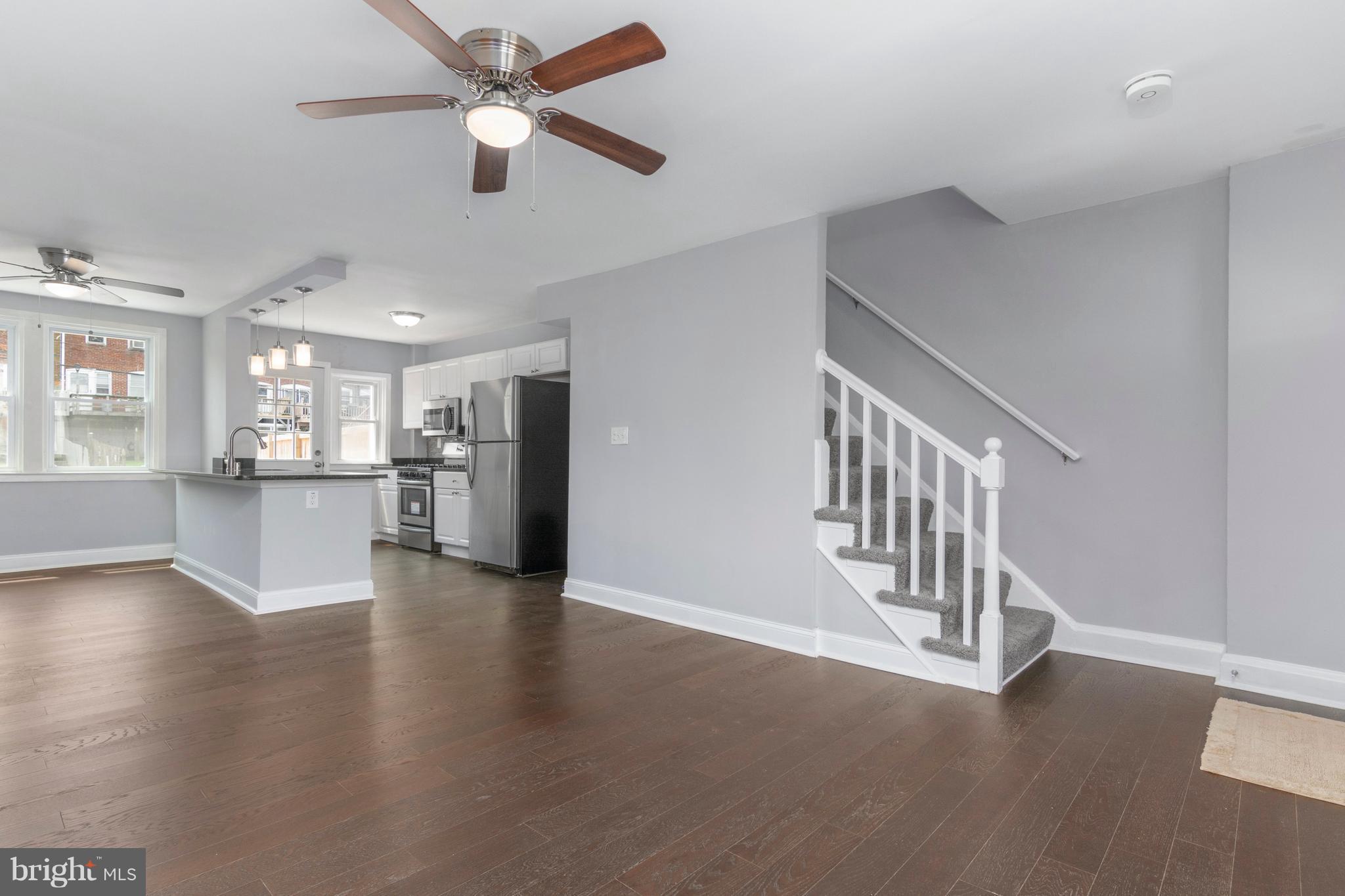 209 West Meadow Road Baltimore, MD 21225 - Photo 5 of 29 a view of a livingroom with wooden floor and a ceiling fan