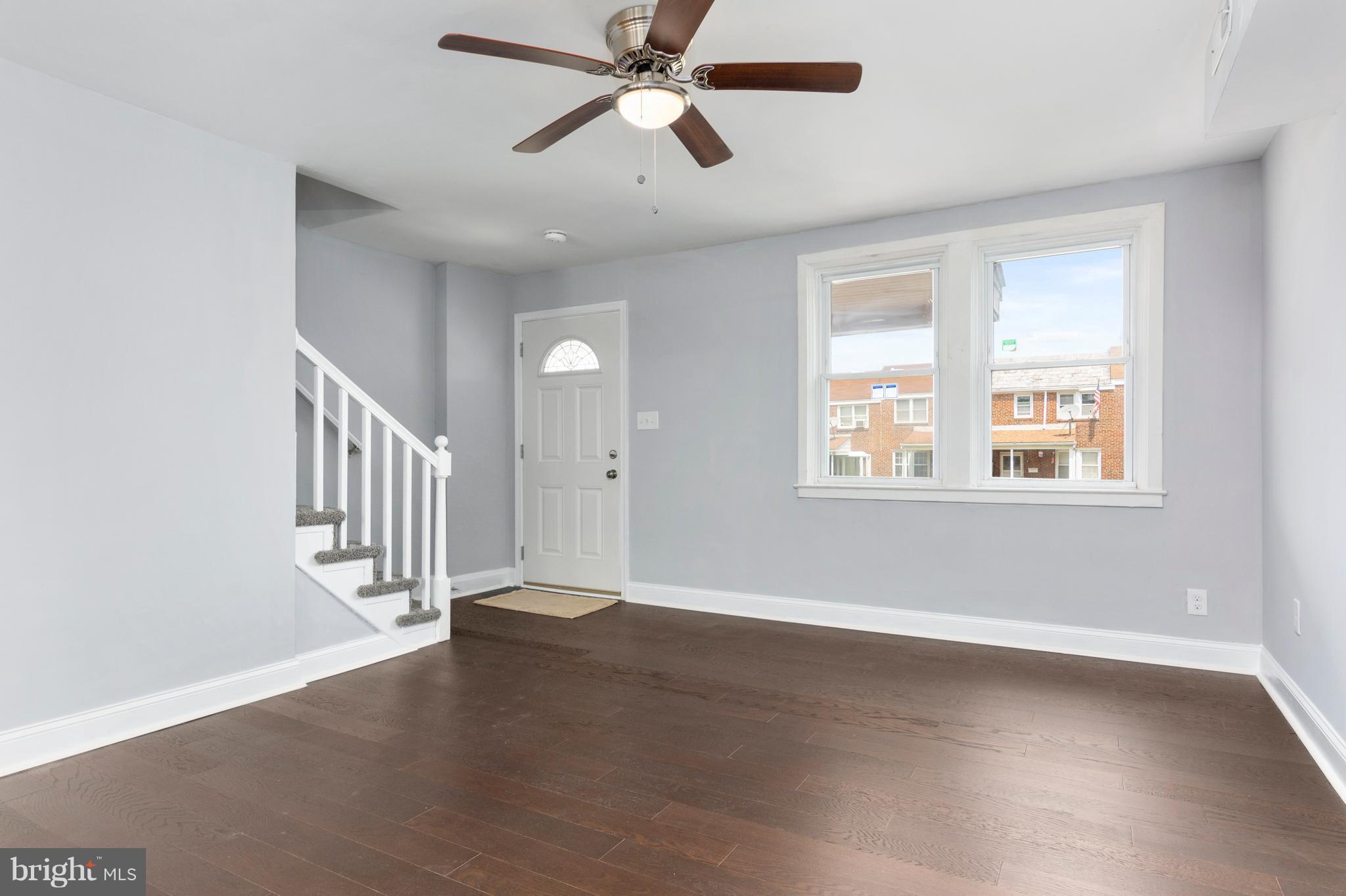 209 West Meadow Road Baltimore, MD 21225 - Photo 6 of 29 a view of an empty room with a window and wooden floor