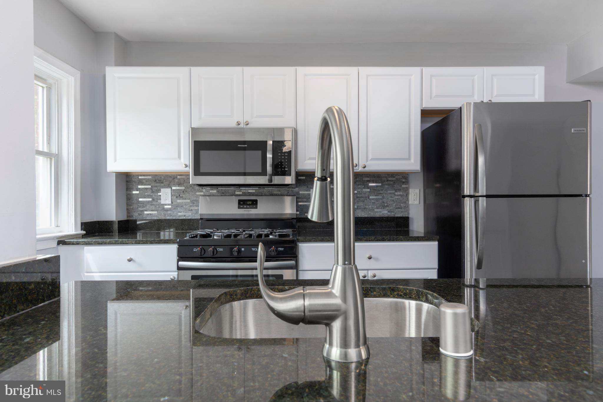 209 West Meadow Road Baltimore, MD 21225 - Photo 8 of 29 a kitchen with stainless steel appliances granite countertop a refrigerator stove and microwave