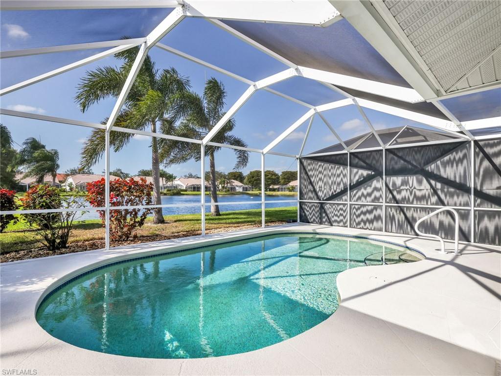 2214 Stacil Circle, Unit 27 Naples, FL 34109 - Photo 17 of 39 a view of a swimming pool with outdoor seating