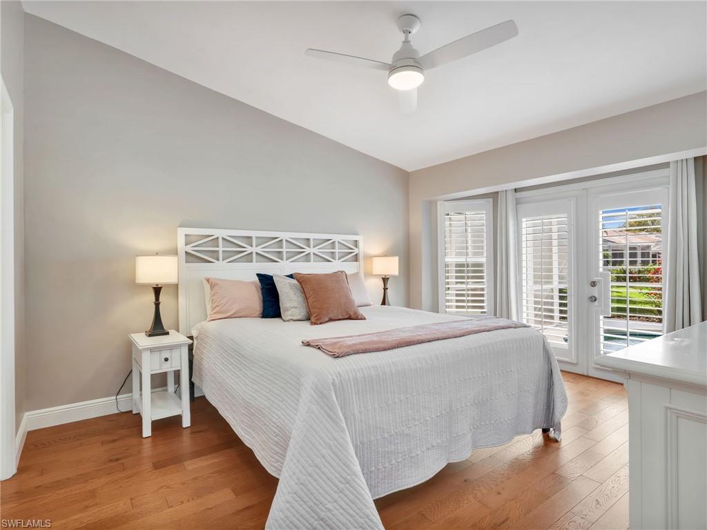 2214 Stacil Circle, Unit 27 Naples, FL 34109 - Photo 18 of 39 a bedroom with a large bed and a large window