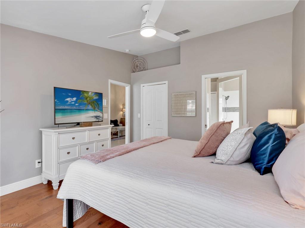 2214 Stacil Circle, Unit 27 Naples, FL 34109 - Photo 19 of 39 a bedroom with a bed and a flat screen tv