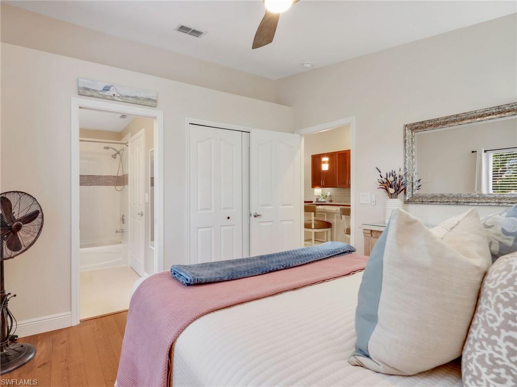 2214 Stacil Circle, Unit 27 Naples, FL 34109 - Photo 23 of 39 a bedroom with a large bed and a couch