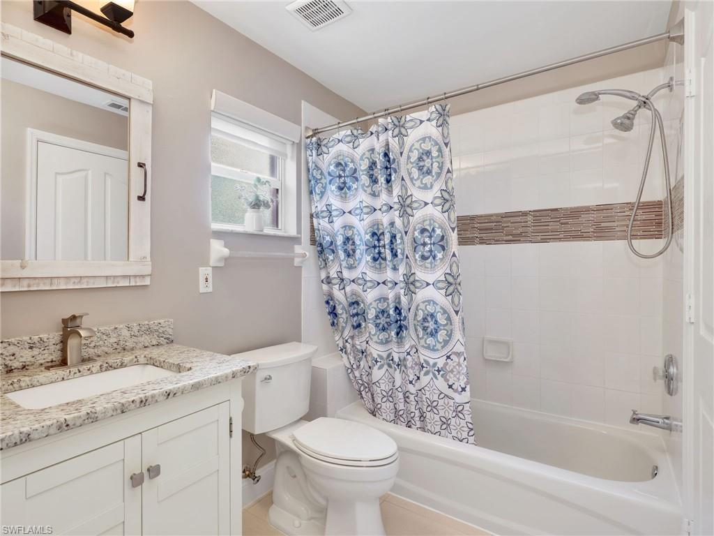 2214 Stacil Circle, Unit 27 Naples, FL 34109 - Photo 24 of 39 a bathroom with a granite countertop sink toilet and shower