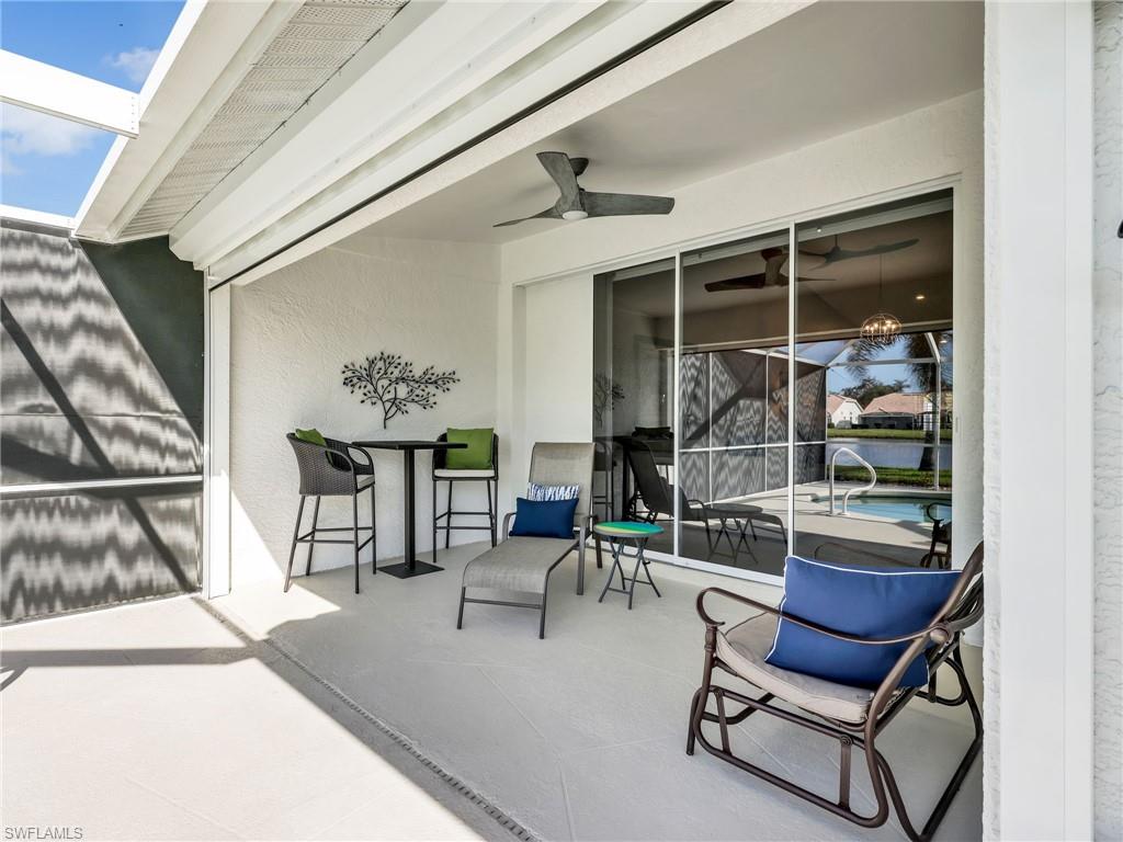 2214 Stacil Circle, Unit 27 Naples, FL 34109 - Photo 27 of 39 a dining room with furniture and a floor to ceiling window