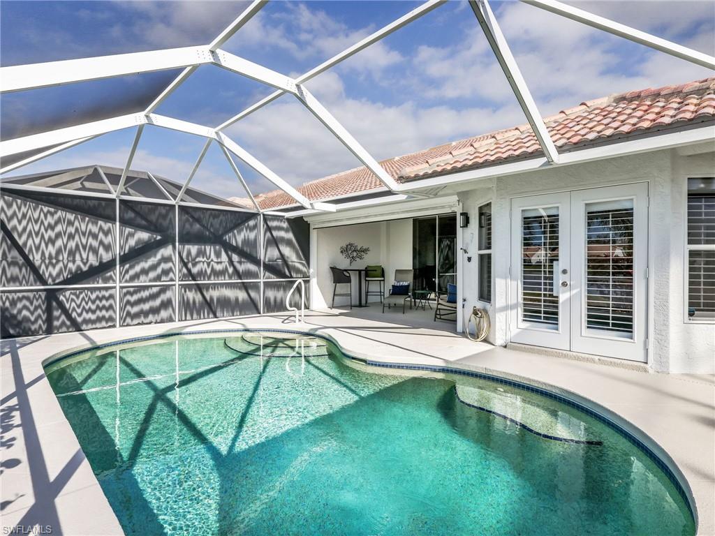 2214 Stacil Circle, Unit 27 Naples, FL 34109 - Photo 29 of 39 a view of a backyard with a swimming pool