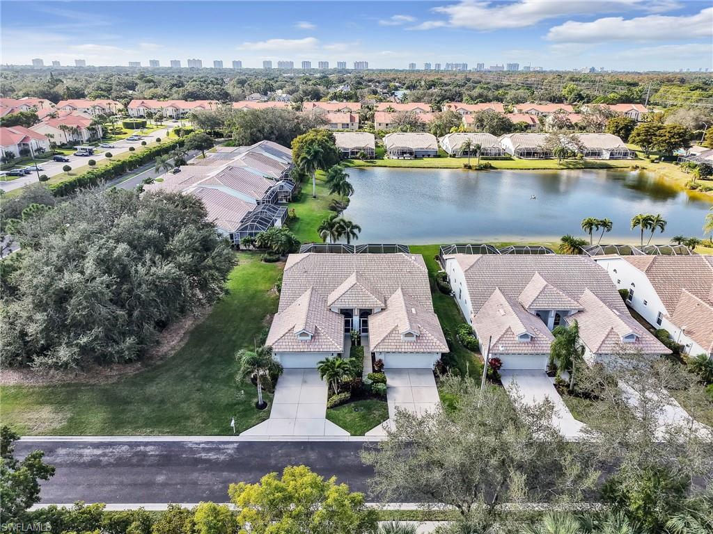 2214 Stacil Circle, Unit 27 Naples, FL 34109 - Photo 32 of 39 an aerial view of a house with a lake view