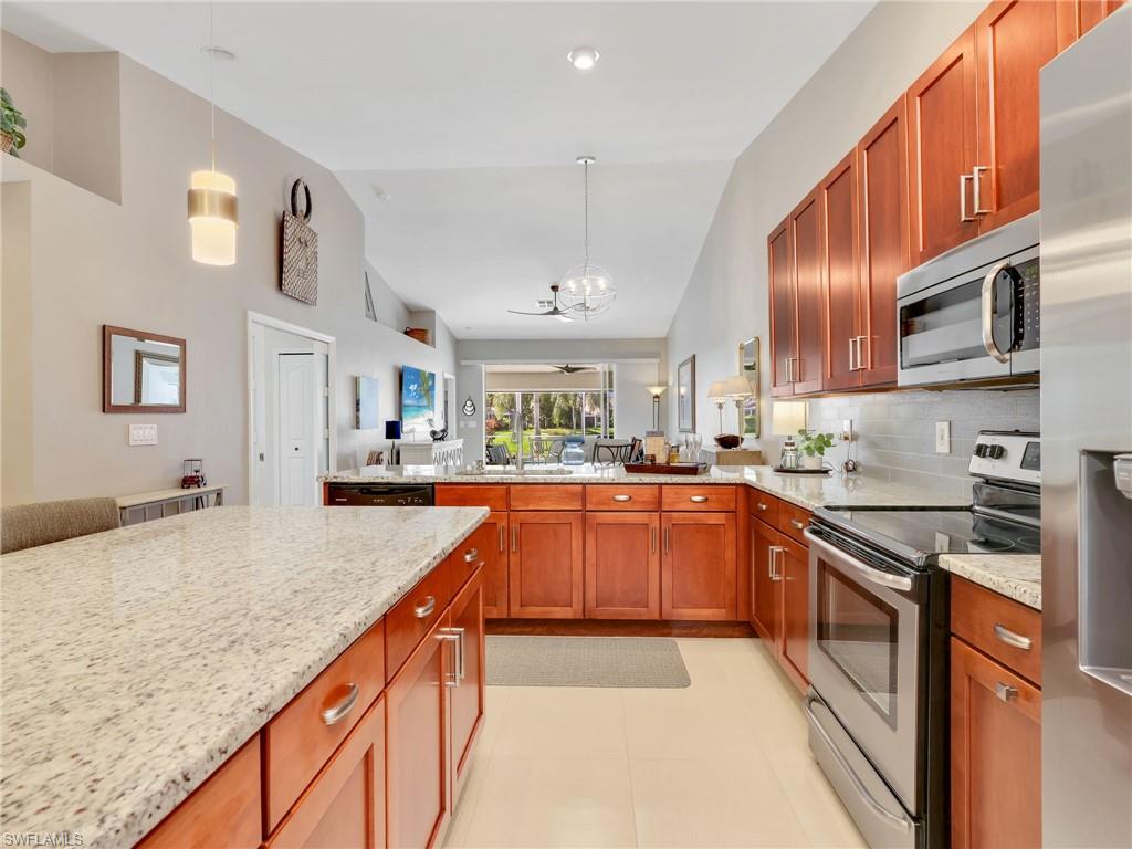 2214 Stacil Circle, Unit 27 Naples, FL 34109 - Photo 7 of 39 a kitchen with stainless steel appliances granite countertop a sink and stove