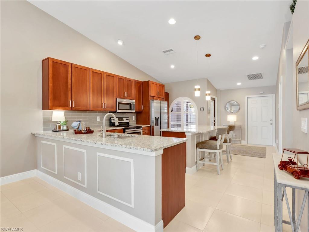 2214 Stacil Circle, Unit 27 Naples, FL 34109 - Photo 8 of 39 a kitchen with stainless steel appliances granite countertop a sink and cabinets