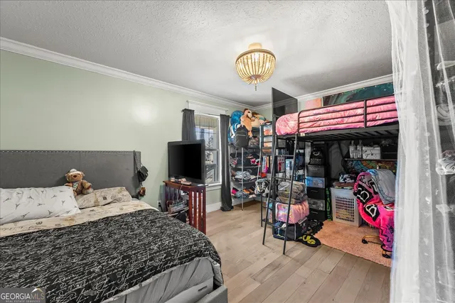 a bedroom with a bed and flat screen tv
