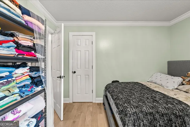 a bedroom with a bed and dresser