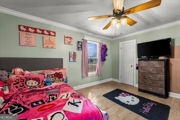 a bedroom with a bed and a tv