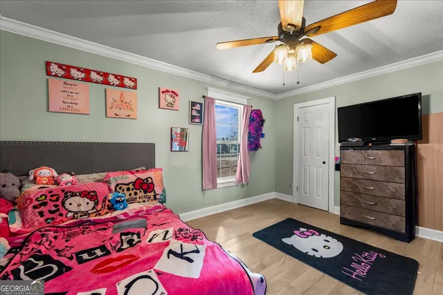 a bedroom with a bed and a tv