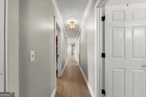 a view of a hallway with wooden floor