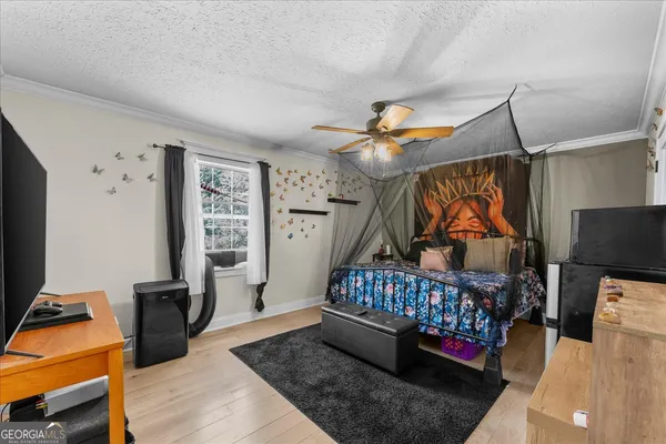 a bedroom with furniture and wooden floor