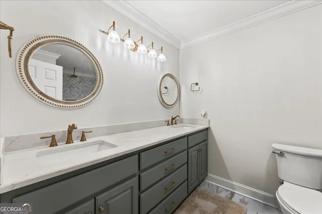 a bathroom with a granite countertop toilet a sink and mirror