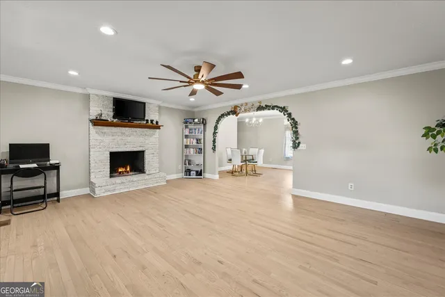 an empty room with windows and a fireplace